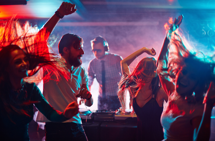 a group of friends dancing at a club at New York. nightclub culture 