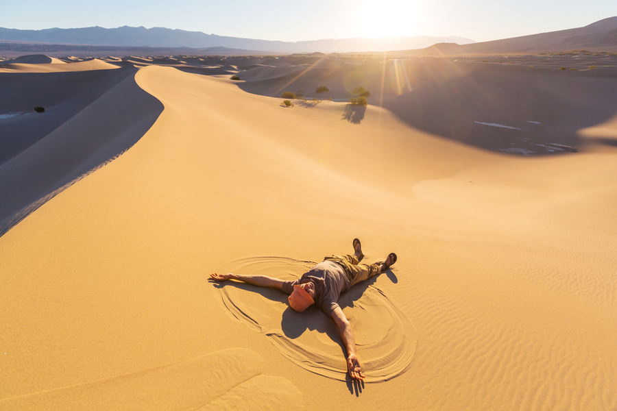 death valley national park in california man lying on sand enjoying the sun im december